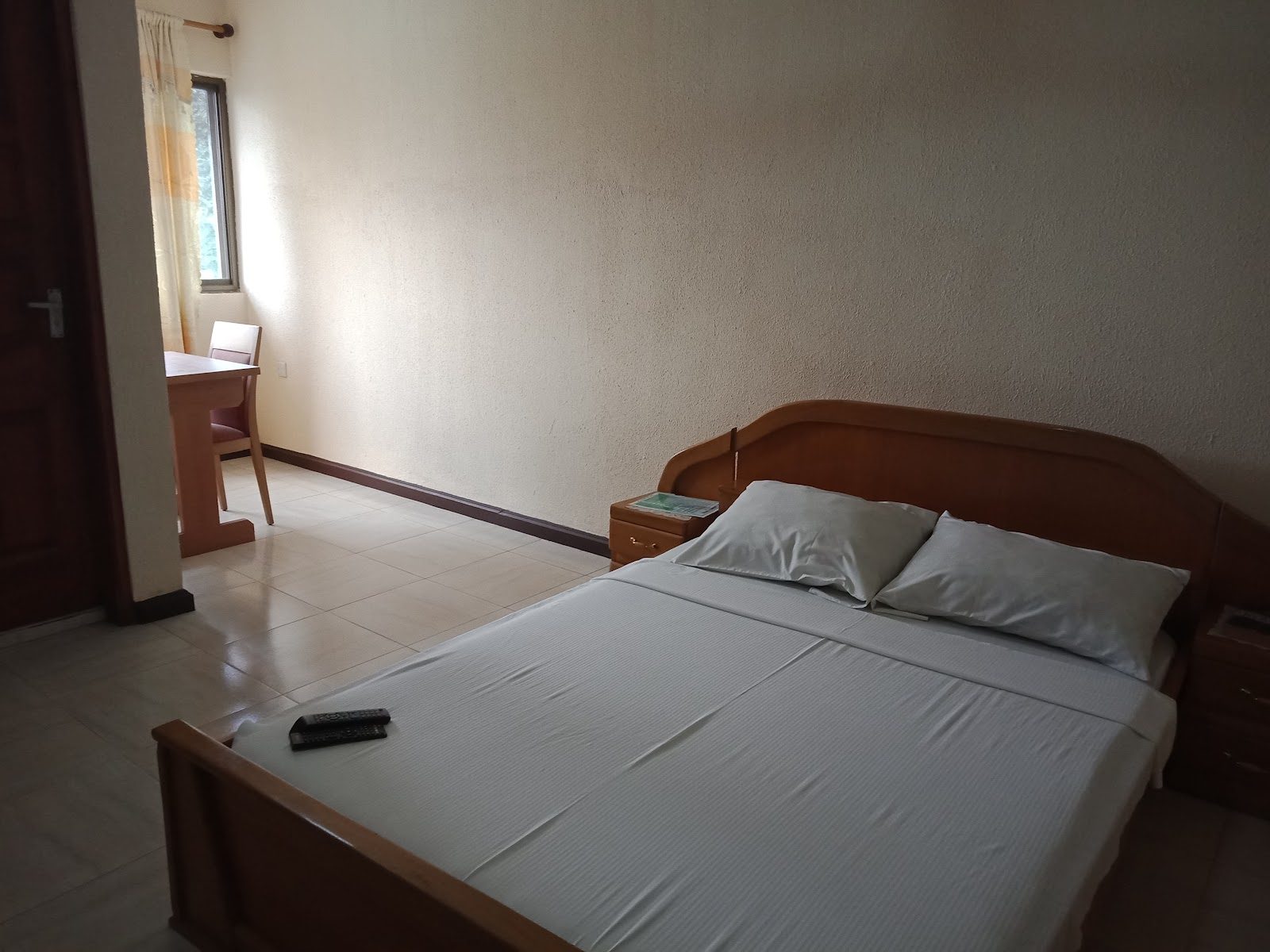 A neat en-suite bedroom at Lasanto Hotel
